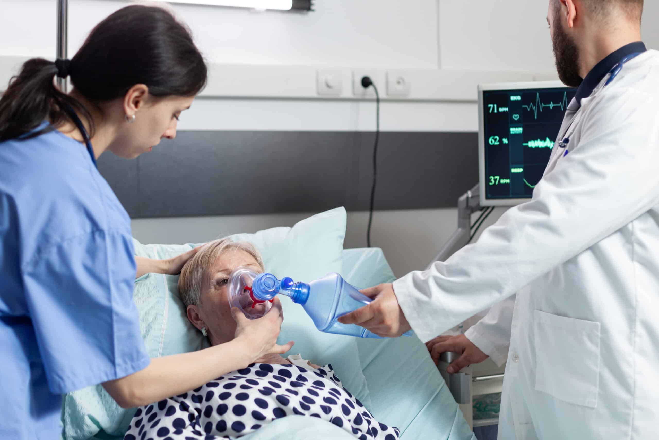 Medical team helping senior woman patient laying in hospital bed